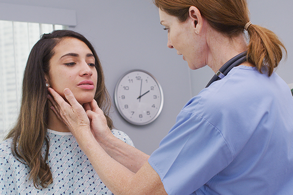 Adult-gerontology primary care nurse practitioner checking a patient's lymph nodes